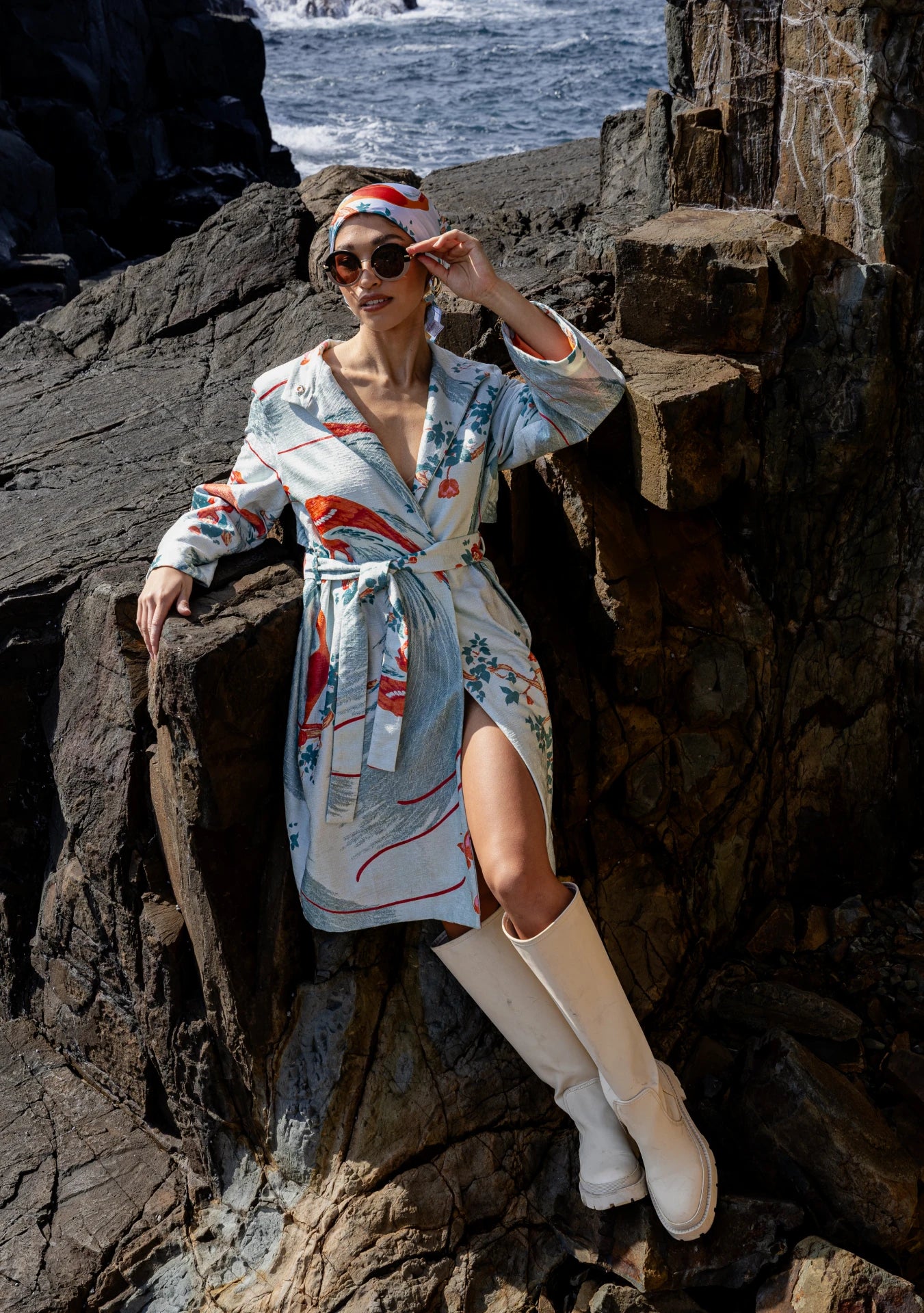 Model wearing the Exotic Birds Coat with rust and mint illustrations, photographed in Amsterdam, Netherlands – cross-cultural fashion by My Paloma.