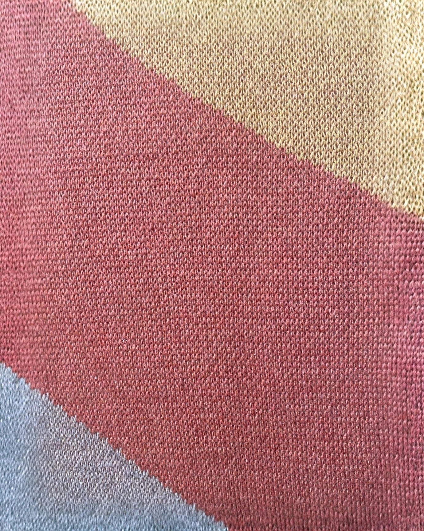 Close-up view of the My Paloma knitwear fabric showcasing the intricate weave and soft wool-blend texture in earthy terracotta, gold, and sandstone tones.
