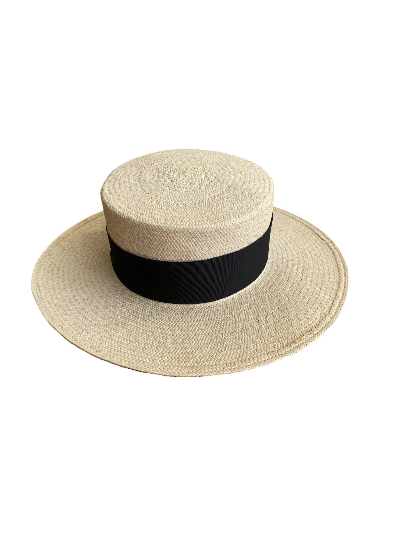 Rear-angled product shot of the Wayra Hat, showcasing its precision weave, wide downturned brim, and clean black ribbon detailing—embodying resort elegance with architectural lines.