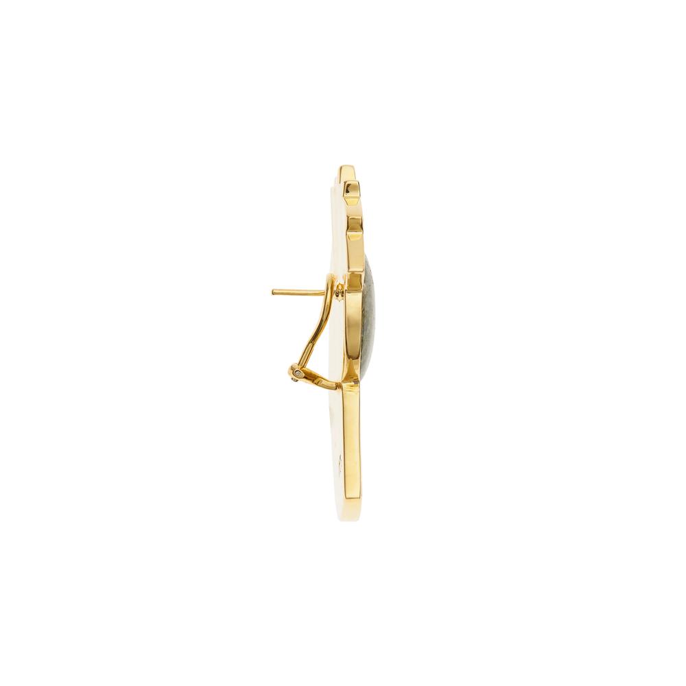 Slim side profile of the earrings, highlighting their sculptural depth and bold curvature.